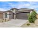 Well-maintained one story home featuring a two car garage and a desert landscaped front yard at 24408 W Ripple Rd, Buckeye, AZ 85326