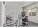 Dedicated hobby room with a window, ample lighting, and specialized furniture for creative pursuits and organization at 24408 W Ripple Rd, Buckeye, AZ 85326