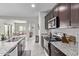 Kitchen with granite countertops, stainless steel appliances, and adjacent dining area at 24408 W Ripple Rd, Buckeye, AZ 85326