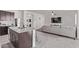 Open concept kitchen that flows into a cozy living room with an entertainment center at 24408 W Ripple Rd, Buckeye, AZ 85326
