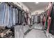 Well-organized walk-in closet with ample hanging space and shelving for clothes, shoes, and accessories at 24408 W Ripple Rd, Buckeye, AZ 85326