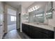Elegant bathroom featuring a double sink vanity with granite countertops and a large mirror at 2514 E Music Mountain Ave, Apache Junction, AZ 85119