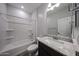A bright bathroom with a granite vanity, dark cabinets, and shower-tub combination at 2514 E Music Mountain Ave, Apache Junction, AZ 85119