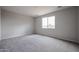 Cozy bedroom featuring neutral paint, carpeting, and a large window at 2514 E Music Mountain Ave, Apache Junction, AZ 85119