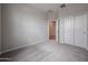 A neutral bedroom features carpet, closet, and a door to another room at 2514 E Music Mountain Ave, Apache Junction, AZ 85119