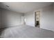 Spacious bedroom featuring neutral walls, soft carpeting, and an en-suite bathroom entrance at 2514 E Music Mountain Ave, Apache Junction, AZ 85119