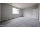 Bright, carpeted bedroom with a large window offering plenty of natural light at 2514 E Music Mountain Ave, Apache Junction, AZ 85119