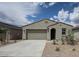 Charming single-story home featuring a neutral stucco facade, a two-car garage, and desert landscaping at 2514 E Music Mountain Ave, Apache Junction, AZ 85119