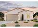 Charming single-story home boasting a stucco facade, tile roof, arched entryway, and a meticulously xeriscaped front yard at 2514 E Music Mountain Ave, Apache Junction, AZ 85119