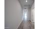 Inviting hallway featuring stylish wood-look tile flooring and a bright, airy atmosphere at 2514 E Music Mountain Ave, Apache Junction, AZ 85119