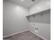 A practical laundry room with tile flooring and built-in shelving above at 2514 E Music Mountain Ave, Apache Junction, AZ 85119