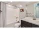 Bright bathroom with a shower-tub, white sink, and decorative wall art at 26978 N 74Th Ln, Peoria, AZ 85383