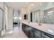 Bathroom featuring dual sinks, modern cabinets, and access to shower and closet at 26978 N 74Th Ln, Peoria, AZ 85383
