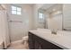 Modern bathroom with dark cabinets, white sink and shower tub at 26978 N 74Th Ln, Peoria, AZ 85383
