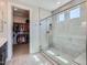 Modern bathroom with glass shower door and access to a large closet at 26978 N 74Th Ln, Peoria, AZ 85383