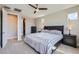 Comfortable bedroom with carpet, ceiling fan, and access to closet at 26978 N 74Th Ln, Peoria, AZ 85383