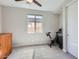 Bright bedroom with a large window, exercise bike, neutral walls, and carpet at 26978 N 74Th Ln, Peoria, AZ 85383