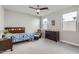 Well-lit bedroom with neutral carpet, ceiling fan, and ample natural light at 26978 N 74Th Ln, Peoria, AZ 85383