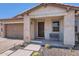 Welcoming front porch with stone accents, desert landscaping, and a cozy seating area at 26978 N 74Th Ln, Peoria, AZ 85383