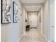 Bright hallway with wood-look tile flooring, neutral walls, and modern decor at 26978 N 74Th Ln, Peoria, AZ 85383