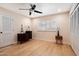 A bedroom featuring wood-look floors, neutral walls, a ceiling fan and double closet doors at 339 W Southern Hills Rd, Phoenix, AZ 85023