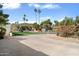 Long driveway leading to a beautiful house, surrounded by lush greenery and tall palm trees at 339 W Southern Hills Rd, Phoenix, AZ 85023