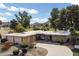 Charming single-story home with stone accents, a circular driveway, and lush landscaping with mature trees at 339 W Southern Hills Rd, Phoenix, AZ 85023