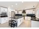 Modern kitchen with white cabinets, stainless steel appliances, an island, and sleek black countertops at 339 W Southern Hills Rd, Phoenix, AZ 85023