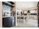Open-concept kitchen and dining area featuring white cabinets, modern appliances, and stylish fixtures at 339 W Southern Hills Rd, Phoenix, AZ 85023