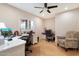 This home office includes two work spaces, a ceiling fan, wood-look floors and plantation shutters at 339 W Southern Hills Rd, Phoenix, AZ 85023