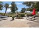 Relax on the back patio with two lounge chairs and an umbrella near the landscaped yard at 339 W Southern Hills Rd, Phoenix, AZ 85023