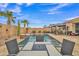 Private backyard oasis features a refreshing pool, waterfall feature, and a serene outdoor dining area for relaxation and enjoyment at 3690 E Blue Spruce Ln, Gilbert, AZ 85298