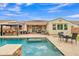 Inviting backyard features a sparkling pool, covered patio, and outdoor dining area, perfect for entertaining and relaxation at 3690 E Blue Spruce Ln, Gilbert, AZ 85298