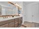 Bright bathroom featuring a double vanity with granite countertops, mosaic backsplash, and walk-in shower at 3690 E Blue Spruce Ln, Gilbert, AZ 85298