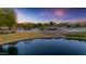 Scenic community park featuring a pond, walking paths, playground, and lush greenery creating a vibrant and active space at 3690 E Blue Spruce Ln, Gilbert, AZ 85298