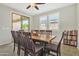 Bright dining room featuring an oversized wood table and chairs, neutral paint, and ample natural light at 3690 E Blue Spruce Ln, Gilbert, AZ 85298
