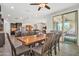 Spacious dining room showcases a large table adjacent to the kitchen and living room for seamless entertaining at 3690 E Blue Spruce Ln, Gilbert, AZ 85298