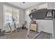 Bright exercise room with neutral colored walls, carpeted floors, and workout equipment at 3690 E Blue Spruce Ln, Gilbert, AZ 85298