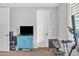 Bright exercise room featuring workout equipment, a TV, and carpeted floors at 3690 E Blue Spruce Ln, Gilbert, AZ 85298