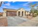 Charming single-story home featuring a two-car garage, arched entryway, and well-maintained desert landscaping at 3690 E Blue Spruce Ln, Gilbert, AZ 85298