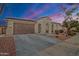 Charming single-story home featuring a two-car garage, arched entryway, and well-maintained desert landscaping at 3690 E Blue Spruce Ln, Gilbert, AZ 85298