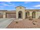 Charming single-story home featuring a two-car garage, arched entryway, and well-maintained desert landscaping at 3690 E Blue Spruce Ln, Gilbert, AZ 85298