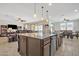 Open-concept kitchen with a center island, stainless steel appliances, and seamless flow to the living and dining areas at 3690 E Blue Spruce Ln, Gilbert, AZ 85298