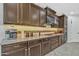 Well-equipped kitchen boasting dark wood cabinetry, granite countertops, and stainless steel appliances for modern living at 3690 E Blue Spruce Ln, Gilbert, AZ 85298