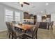 Dining room featuring views into the modern kitchen with granite countertops, stainless steel appliances and dark cabinets at 3690 E Blue Spruce Ln, Gilbert, AZ 85298