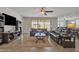Cozy living room boasts a plush leather sofa, chairs, a ceiling fan, and sliding glass doors to the backyard at 3690 E Blue Spruce Ln, Gilbert, AZ 85298