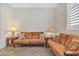 Comfortable living room with a brown sofa and lamps, offering a cozy space to relax at 3690 E Blue Spruce Ln, Gilbert, AZ 85298