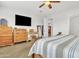 Bright main bedroom with wood furniture, a ceiling fan, and neutral walls, creating a serene retreat at 3690 E Blue Spruce Ln, Gilbert, AZ 85298