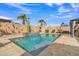 Backyard pool area with waterfall feature, lush landscaping, and clear blue water at 3690 E Blue Spruce Ln, Gilbert, AZ 85298