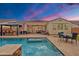 Inviting backyard pool and patio area with lush landscaping and comfortable seating, perfect for outdoor living at 3690 E Blue Spruce Ln, Gilbert, AZ 85298